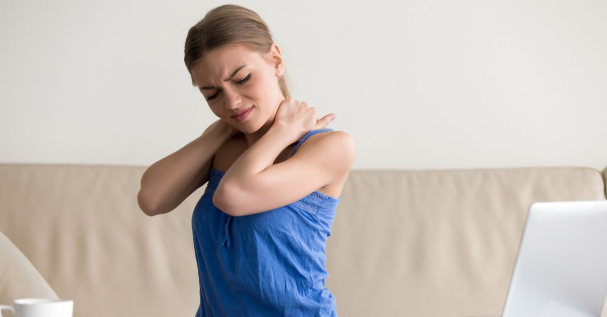 woman holding neck in pain